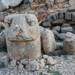 The colossal stone heads of Mount Nemrut, scattered before an ancient royal tomb.