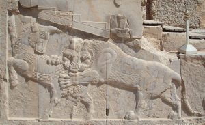 The relief of a lion attacking a bull, a recurring motif at Persepolis.