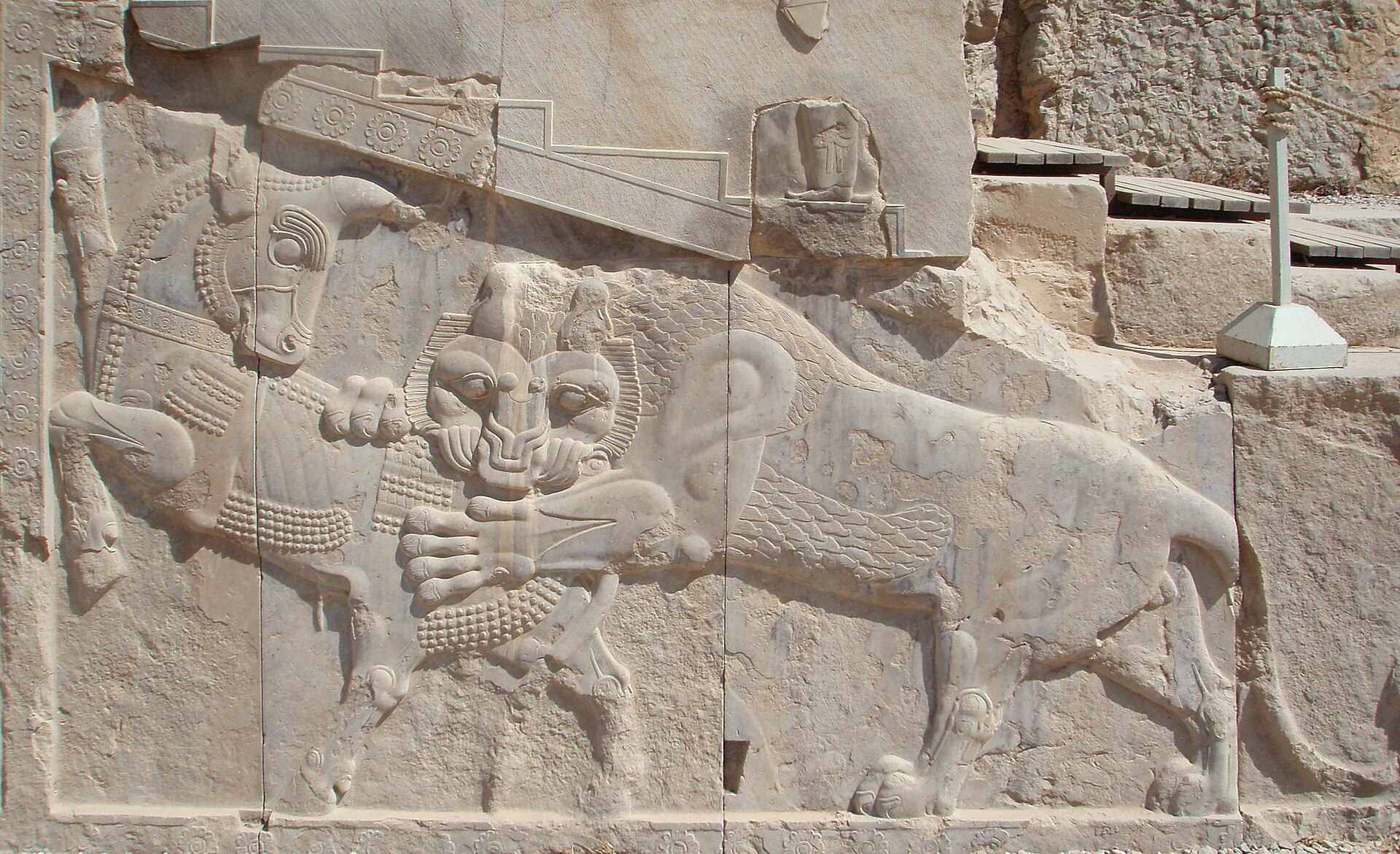 The relief of a lion attacking a bull, a recurring motif at Persepolis.