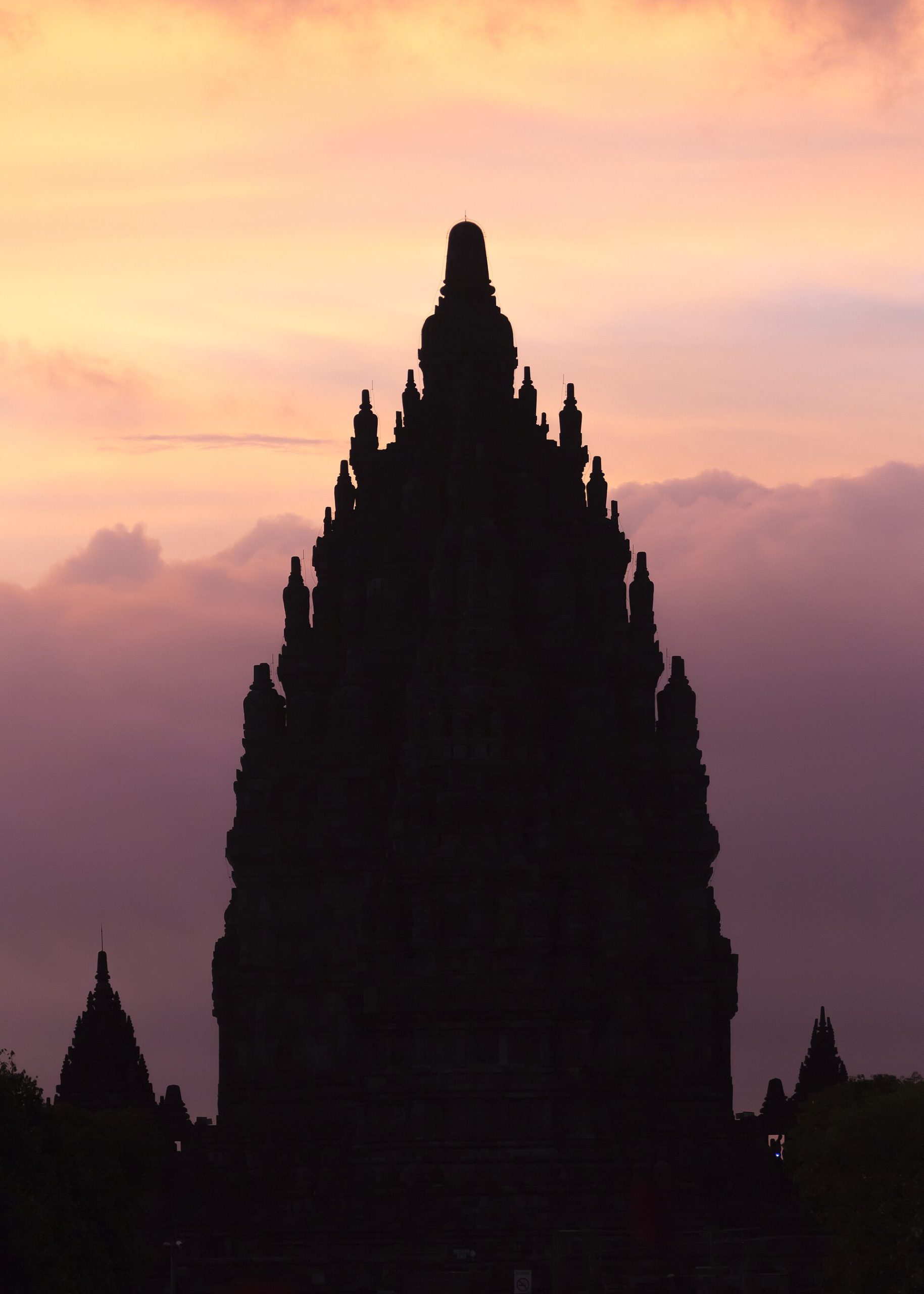 The temples of Prambanan silhouetted against the Javanese sky.