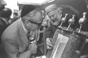 A Samaritan high priest with the Torah; the priesthood leads the community.
