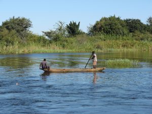 Locals in a canoe on the Zambezi; the Sena are farmers and fishers of the river.