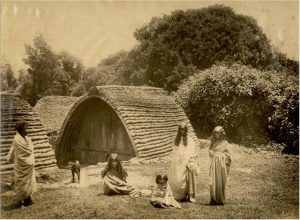 Toda people before their distinctive hut, Nilgiri hills