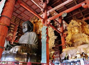 Inside the Daibutsuden, attendant bodhisattvas flank the towering seated Buddha