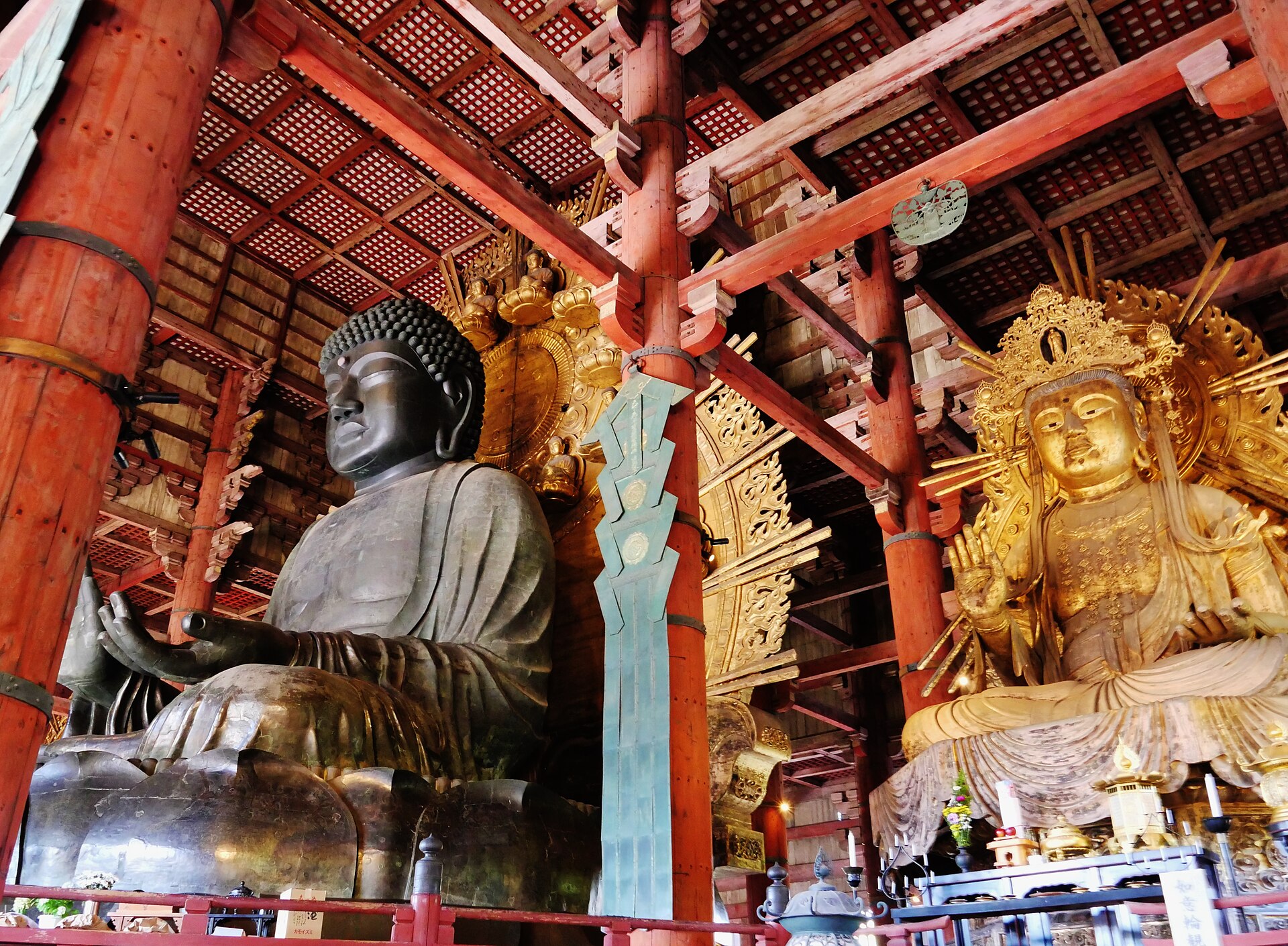 Inside the Daibutsuden, attendant bodhisattvas flank the towering seated Buddha
