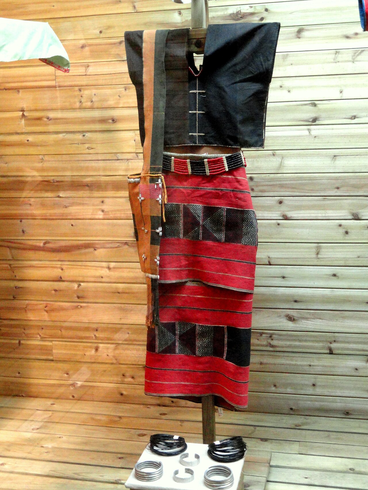 A Wa woman in brocade dress