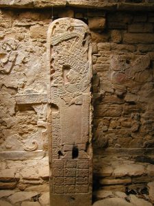 A carved stela at Yaxchilan depicting a Maya ruler in ceremonial dress.