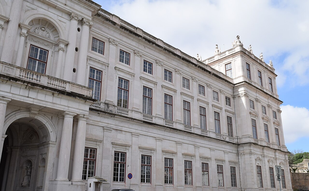 The long columned frontage of the palace above the city.