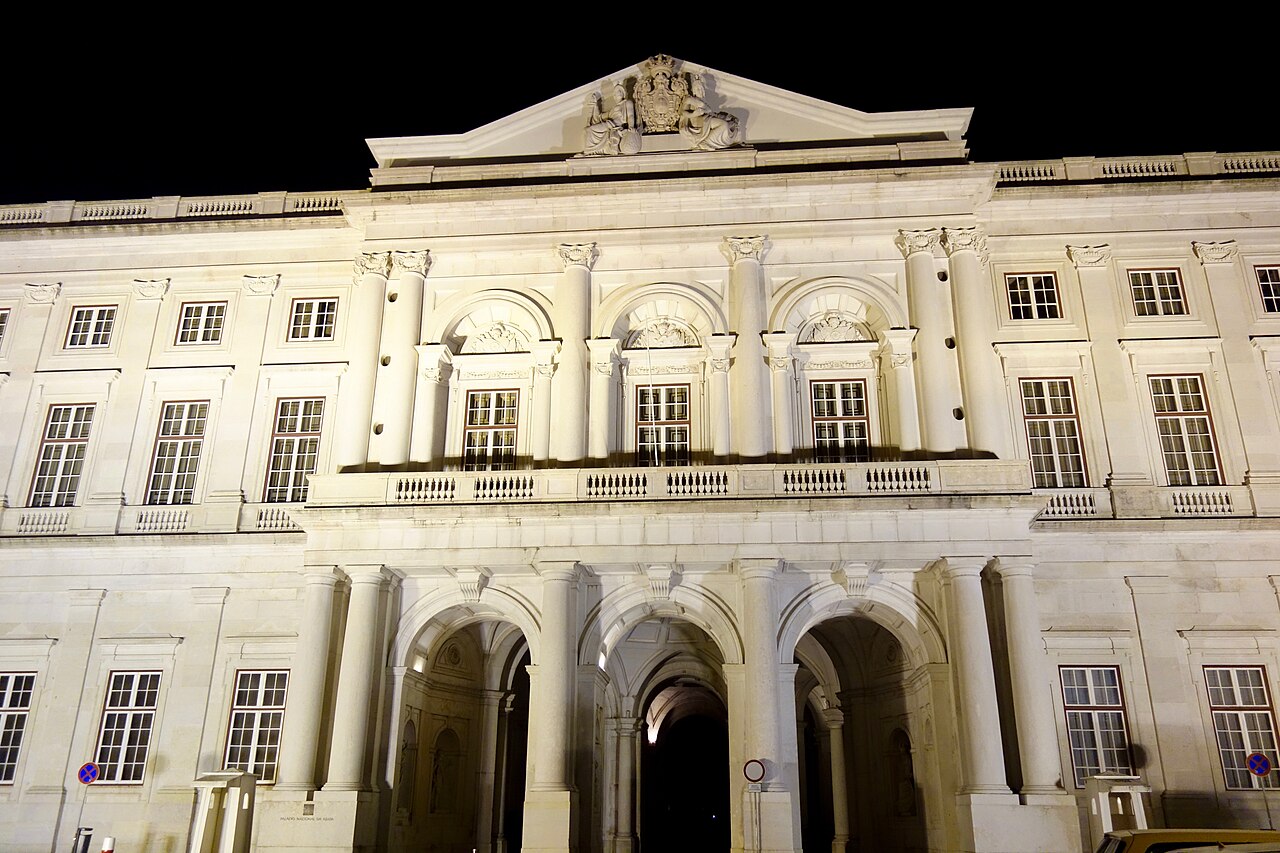 The palace facade illuminated at night.
