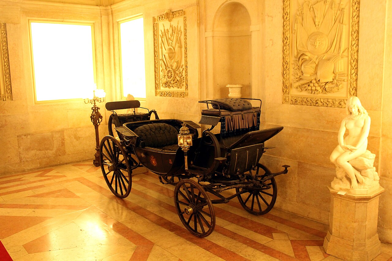 The vestibule with a state coach and sculpture.