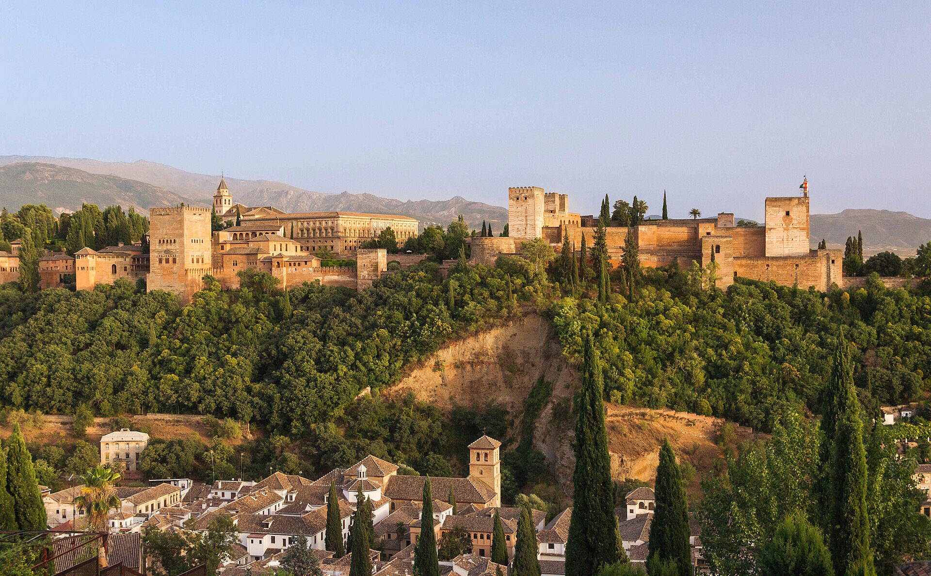 The red walls of the Alhambra on its hill above Granada