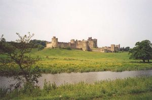 The castle rising above the Aln, its parkland landscaped in the eighteenth century by Capability Brown