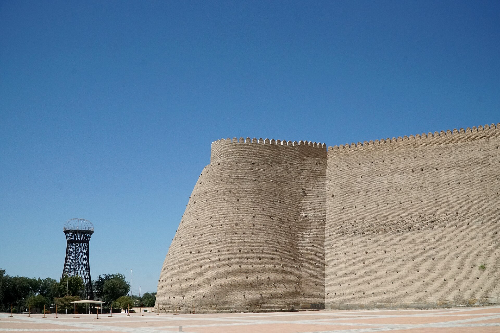 A round tower rising from the sloping ramparts of the citadel