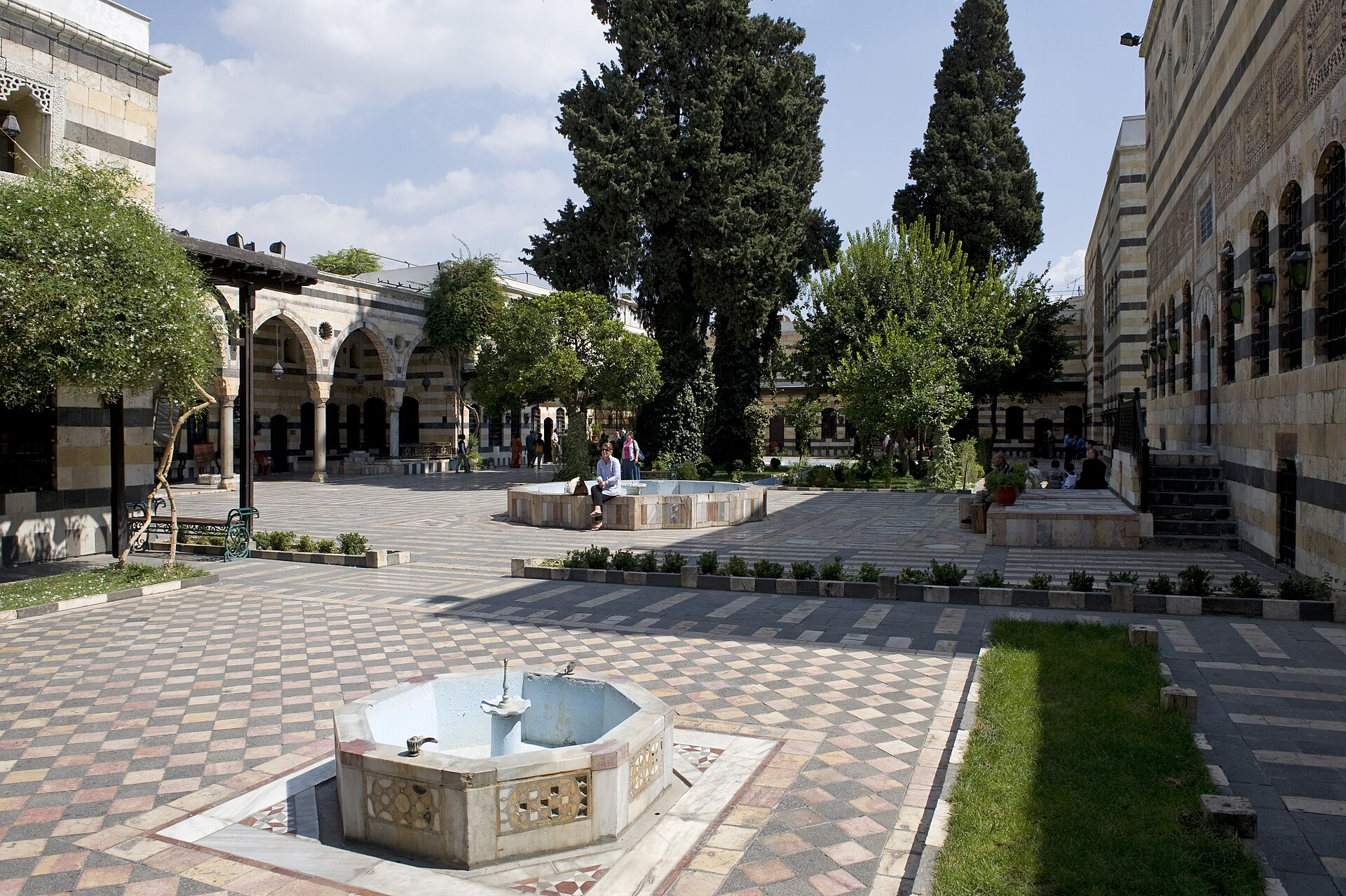 The paved courtyard of the palace with its central pool