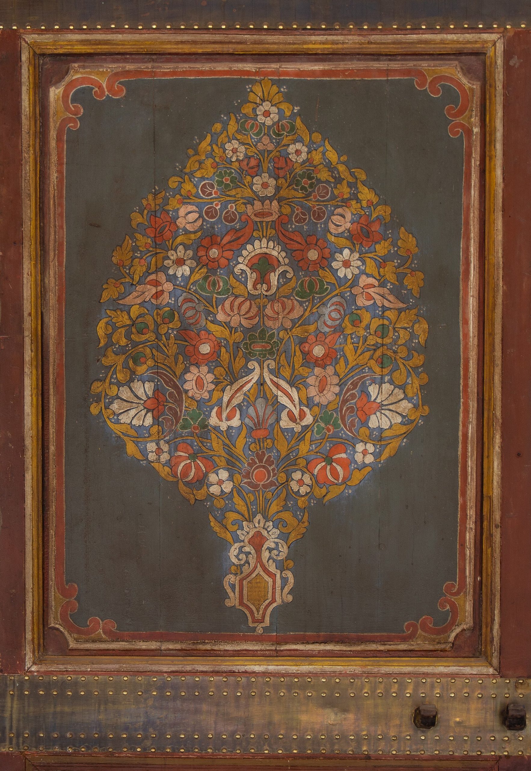 The intricate decoration of a doorway, rich with tilework and carved detail.