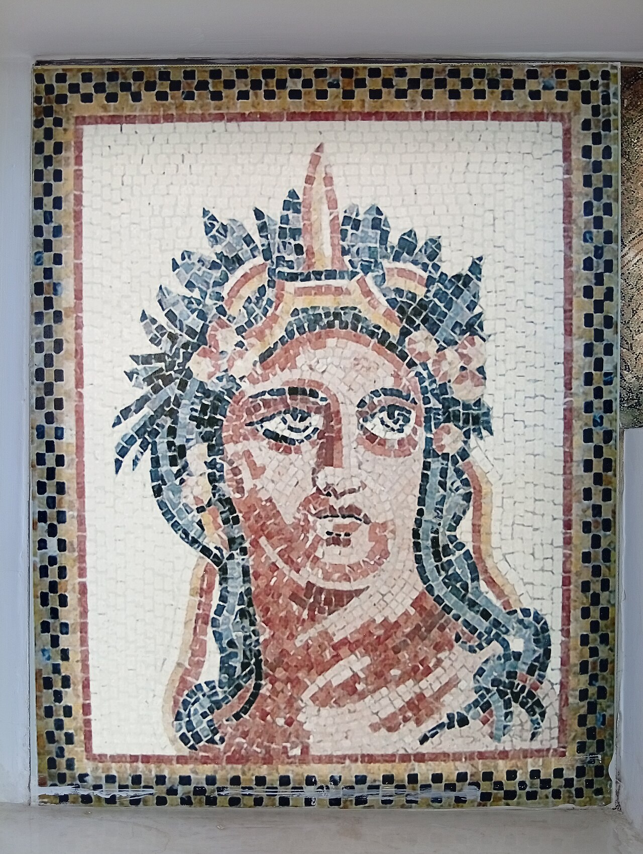 A gallery of the museum lined with mosaics.