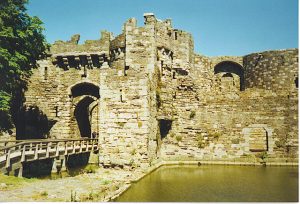 The castle's gatehouse reflected in its surviving moat, once linked to the sea by a tidal dock