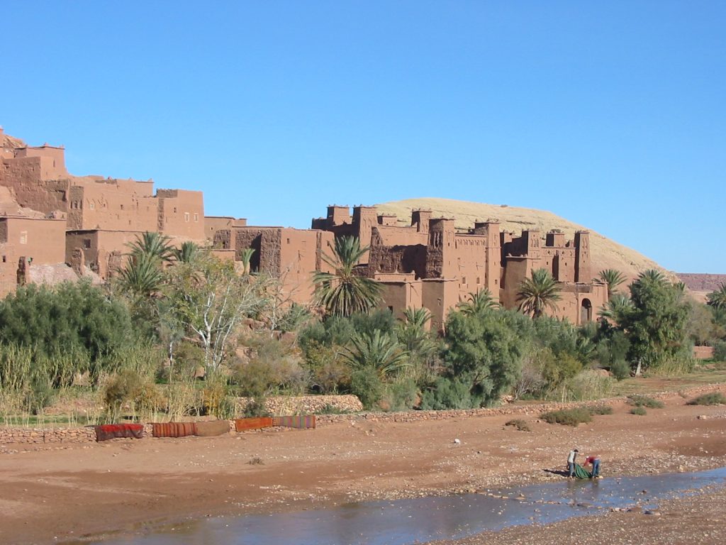 The clustered earthen towers of Aït Benhaddou glowing at sunset