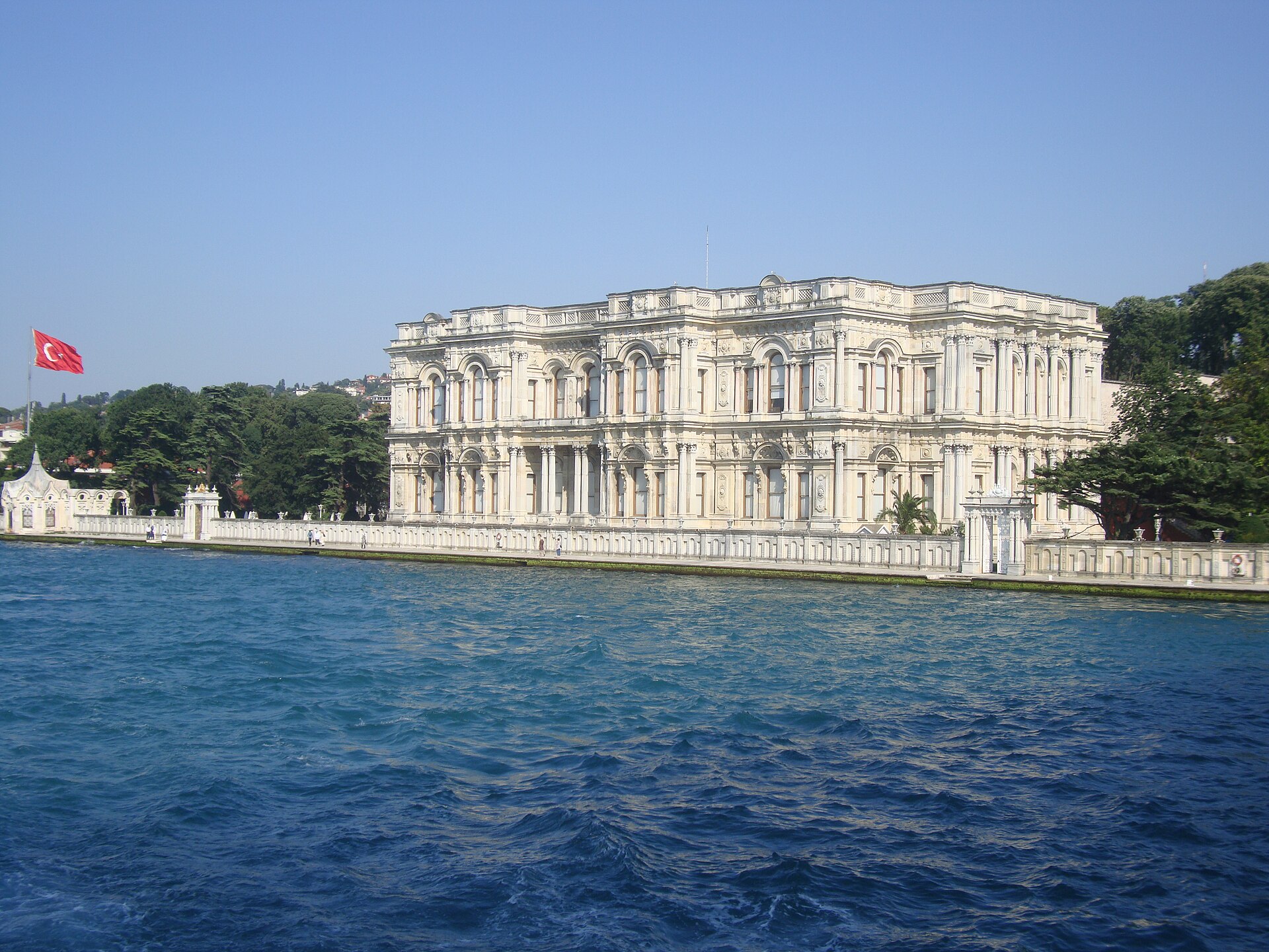 Beylerbeyi Palace on the Asian shore of the Bosphorus, its white marble facade reflected in the strait.