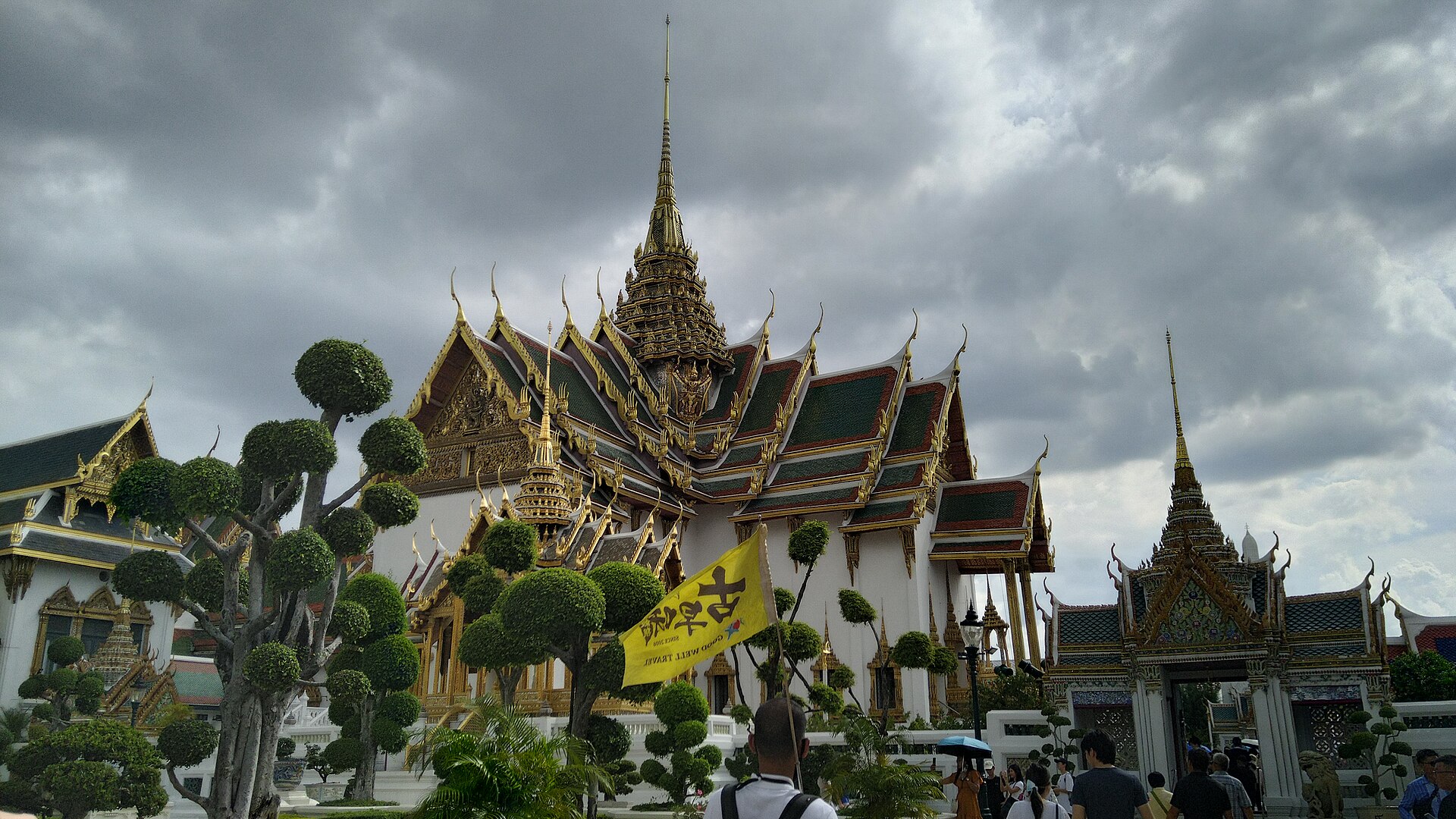 An ornate building of the palace, crowned with traditional Thai tiered roofs and spires.