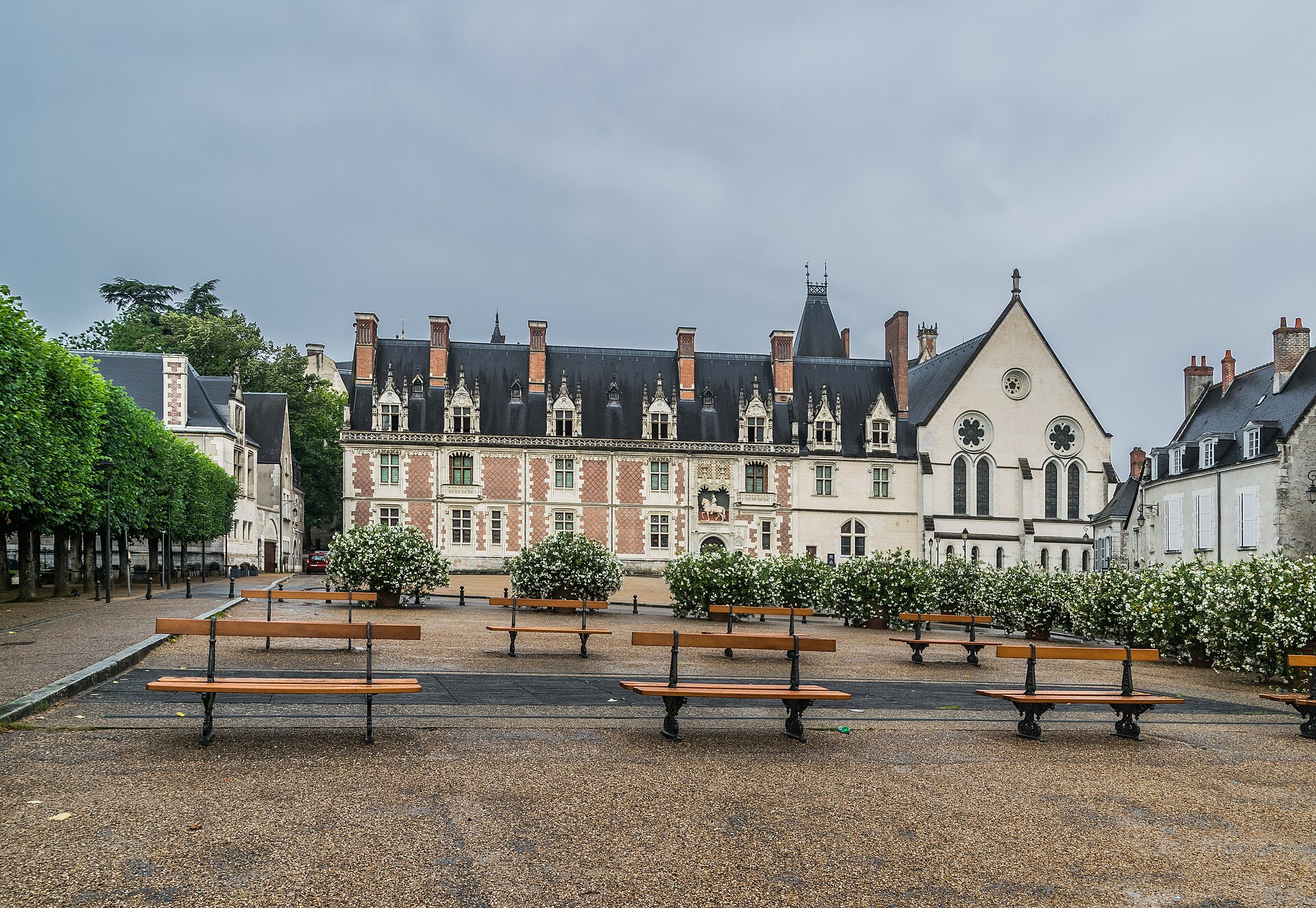 The brick and stone Louis XII wing facing the town