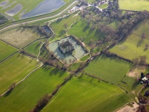 Bodiam from above, a neat square of towers and walls set within a wide rectangular moat