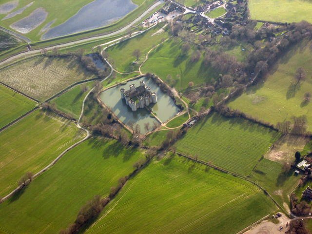 Bodiam from above, a neat square of towers and walls set within a wide rectangular moat