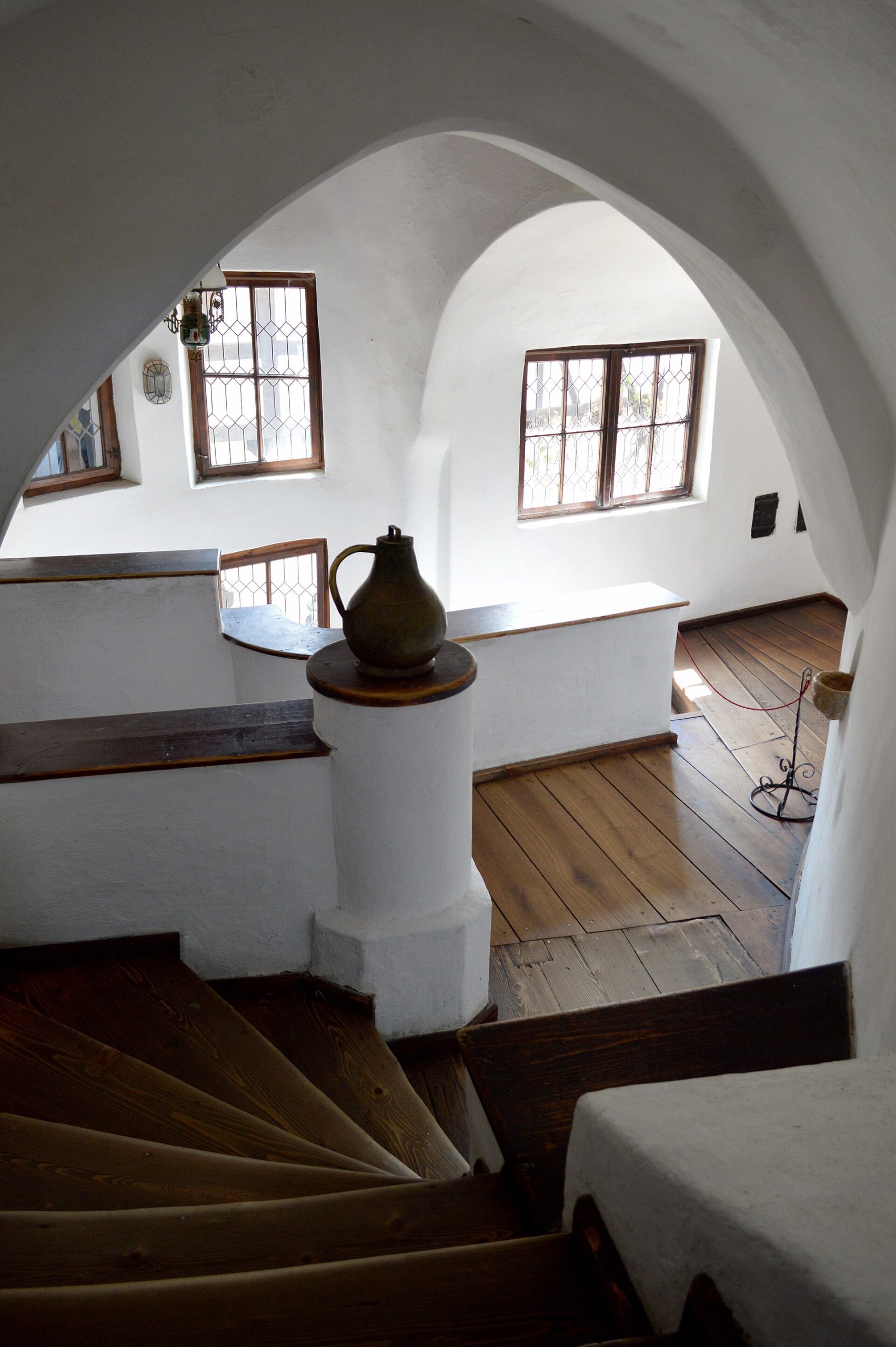 Steep, narrow staircases thread between the castle's stacked levels and secret passages.