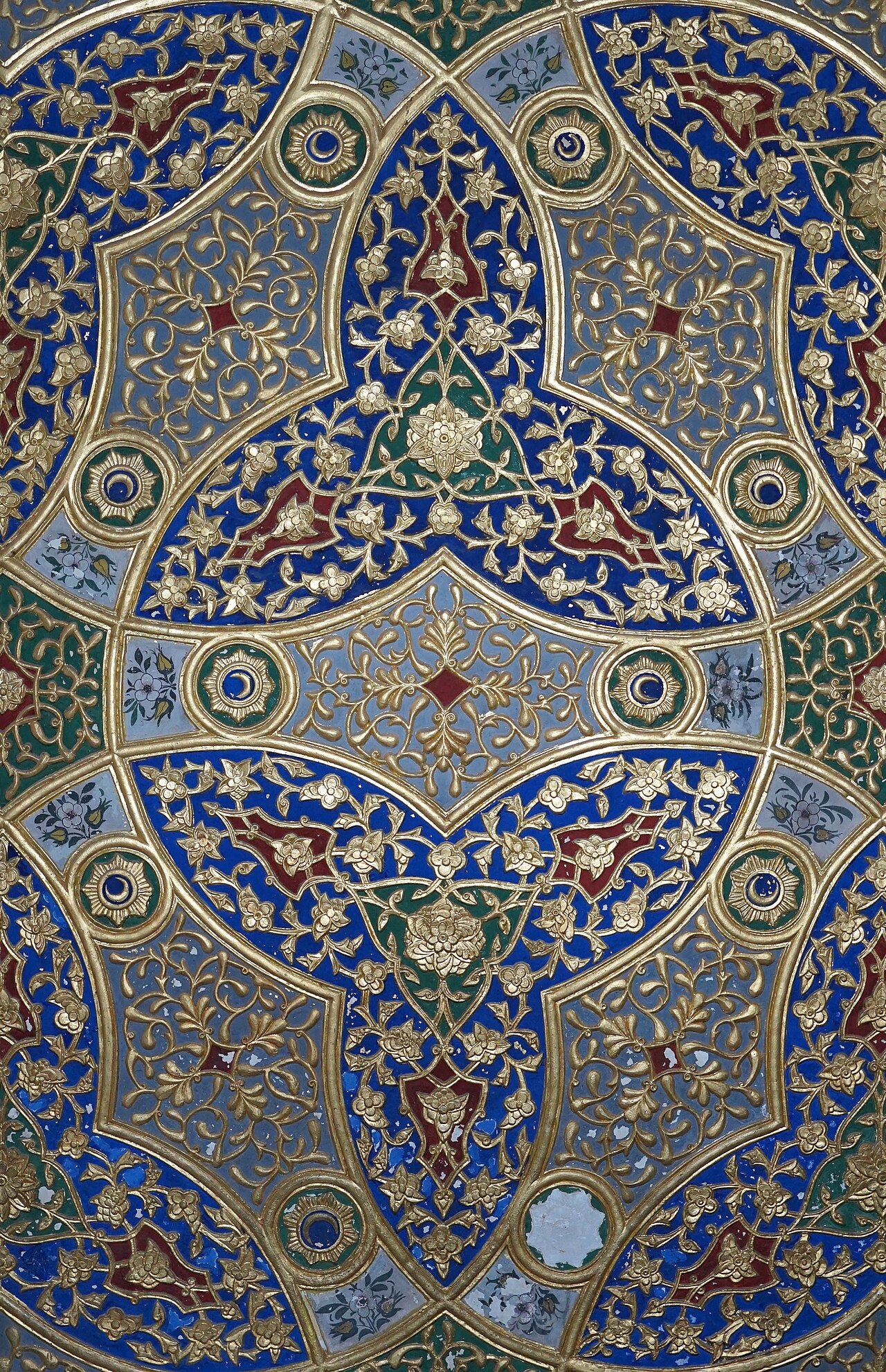 Rich decoration covering the walls and ceilings of a state room.