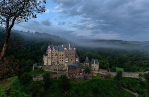 Burg Eltz rising through the morning mist of the Elzbach valley