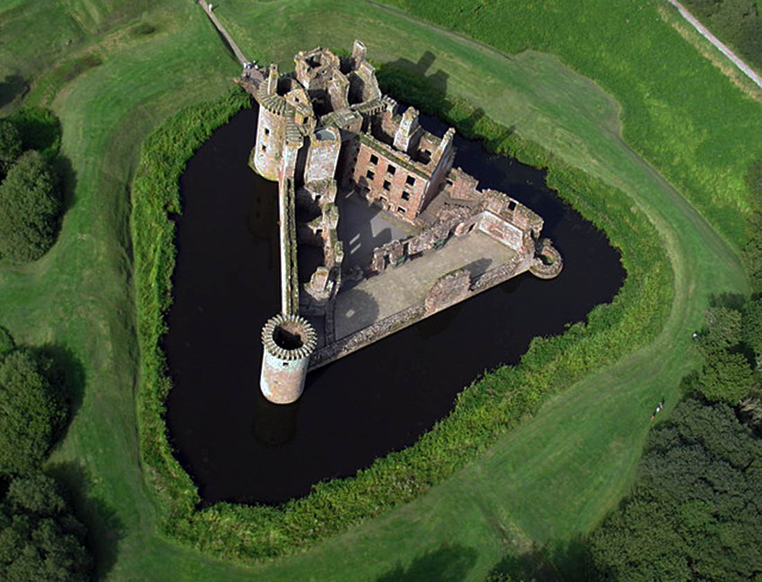 Caerlaverock Castle from the air, its unique triangular plan ringed by a broad moat in south-west Scotland