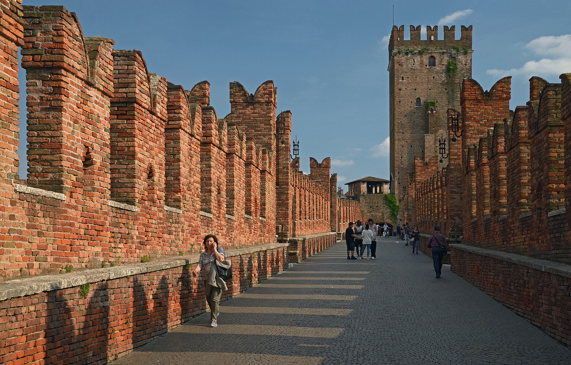 At sunset the brick fortress and its bridge glow above the river.