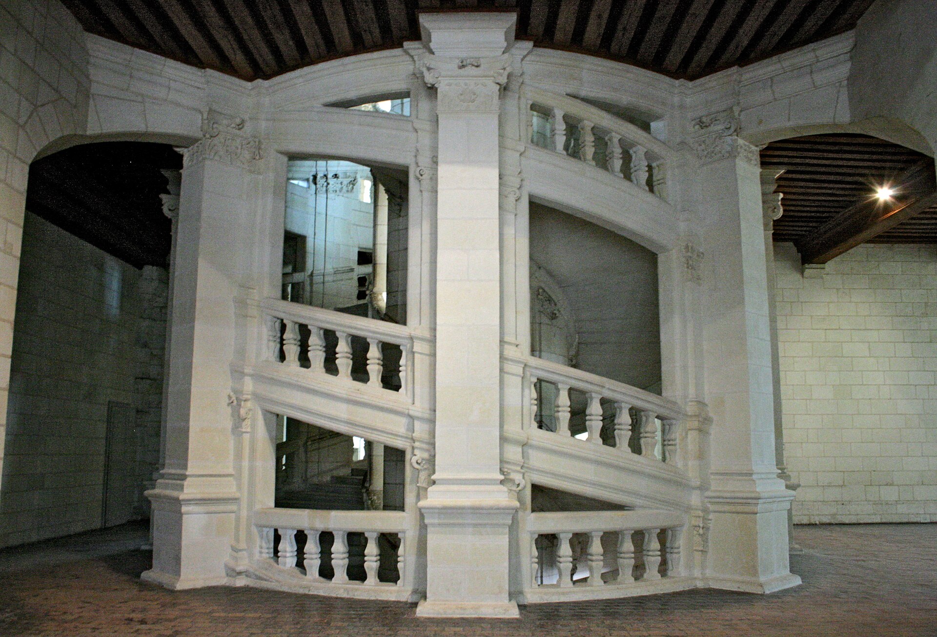 The central staircase of Chambord, climbing toward the light