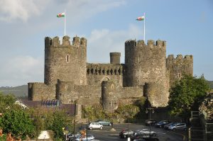 Conwy seen from across the water, its towers reflected in the tidal estuary