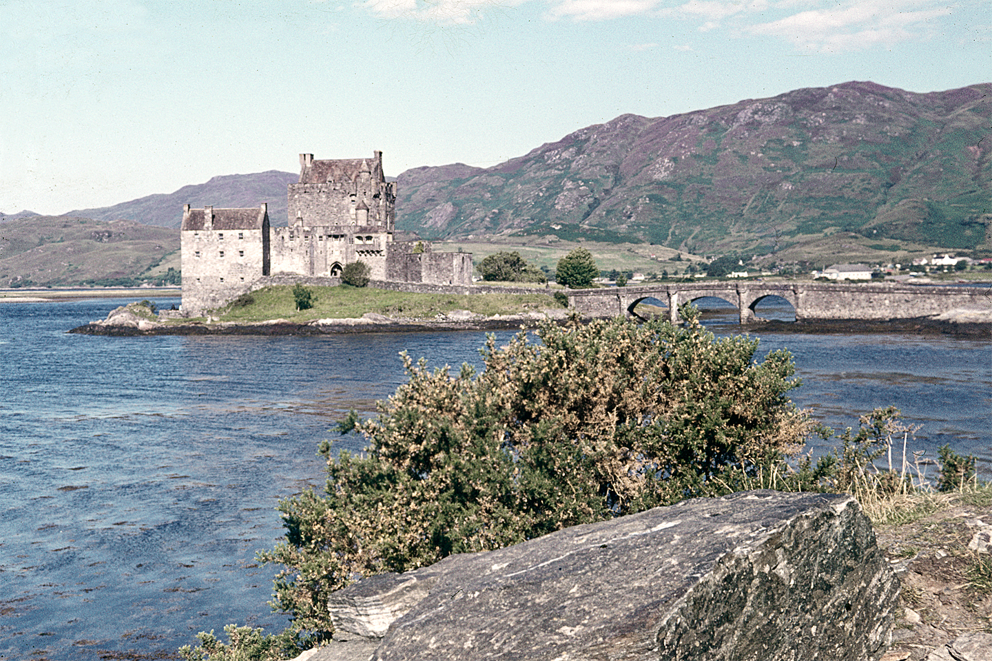 The castle mirrored in the still waters of Loch Duich, framed by the hills of the Scottish Highlands