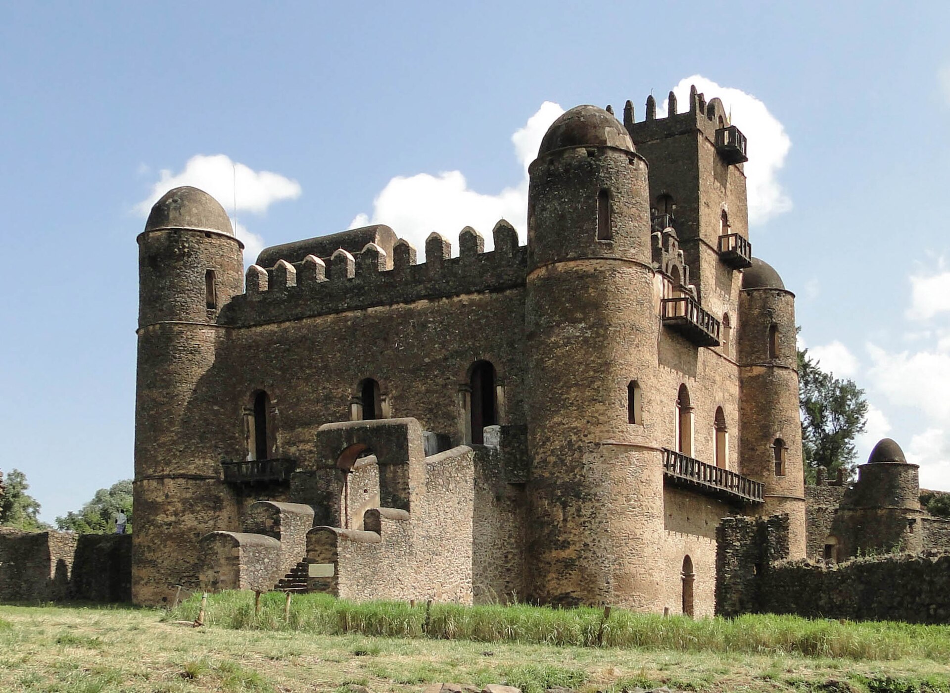A castle of the royal enclosure, its towers and battlements rising against the highland sky.