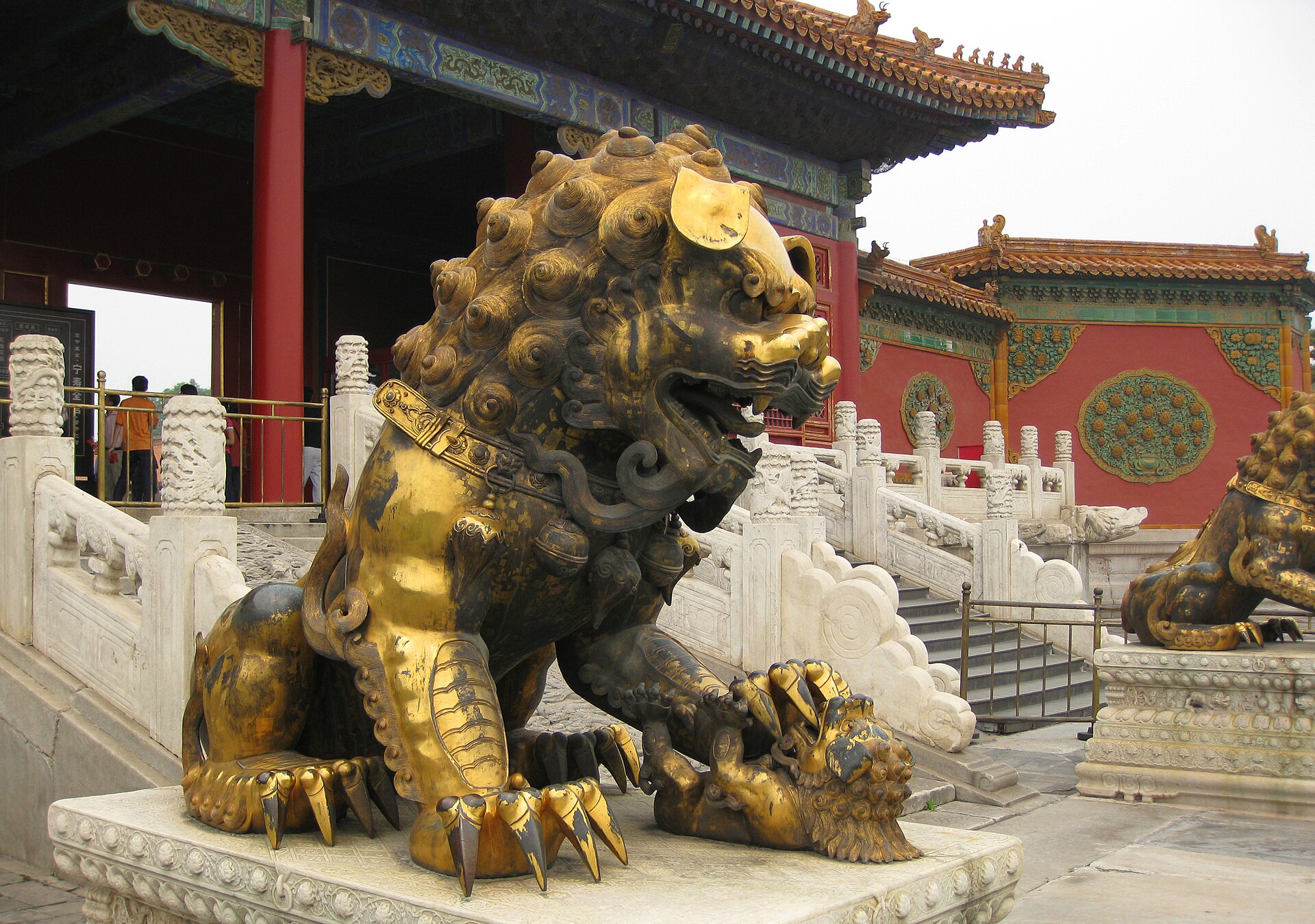 A gilded lion guarding the palace, one of the symbolic figures that adorn the Forbidden City.
