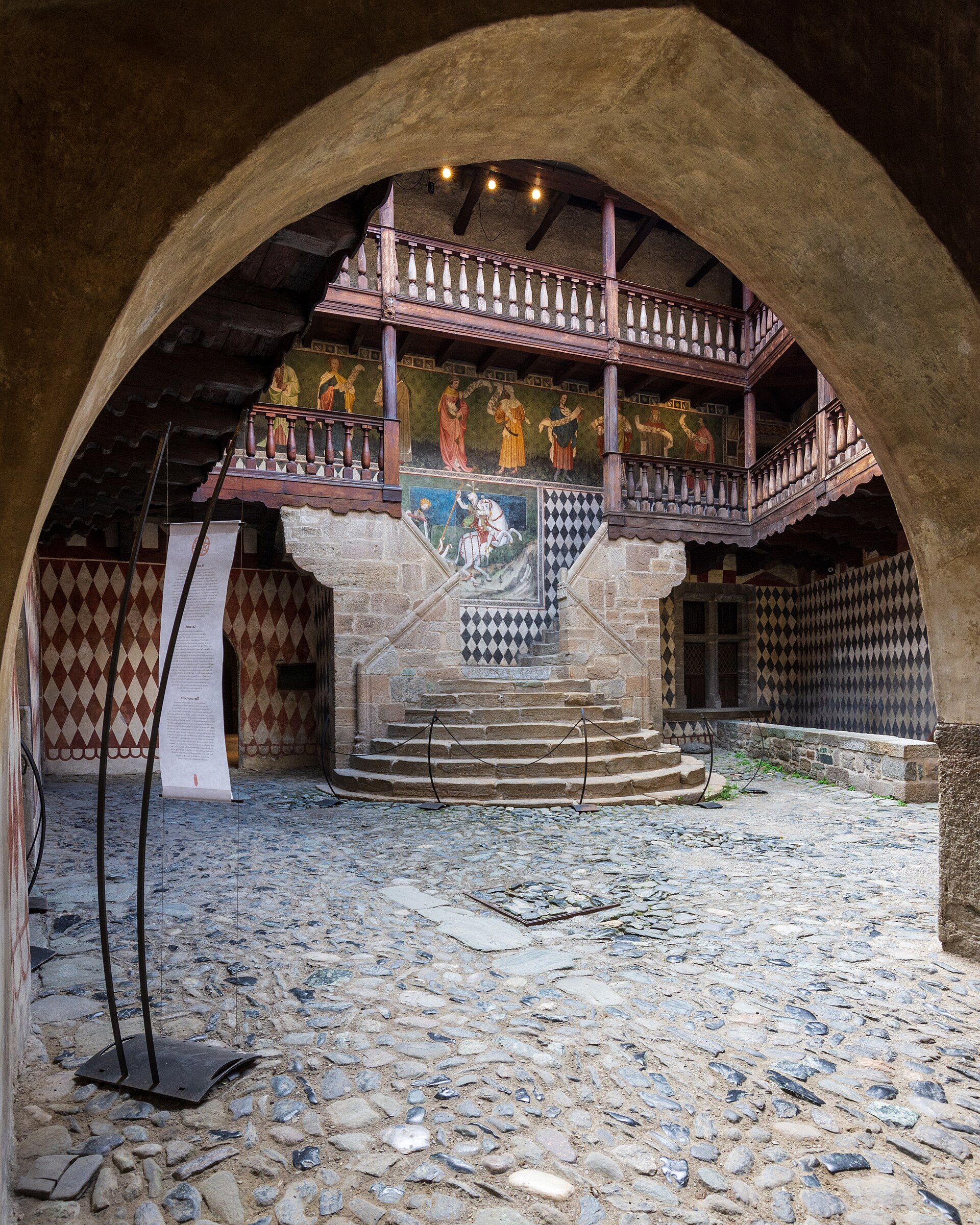 On the courtyard wall, a painted Saint George forever drives his lance into the dragon.