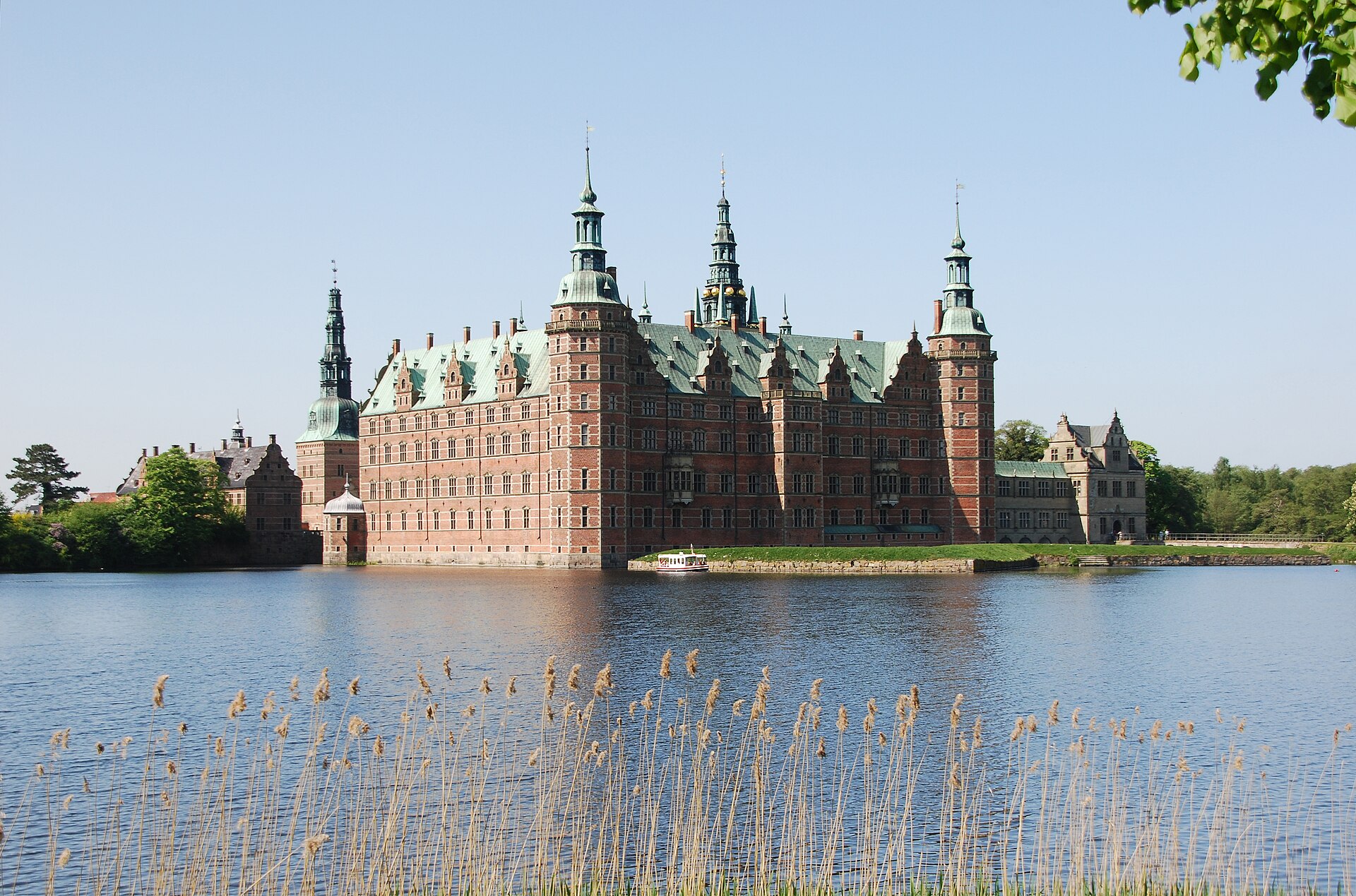Across the lake, formal Baroque gardens rise in terraces, cascades and clipped parterres.