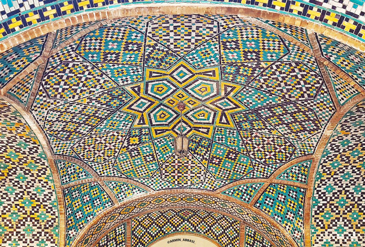 The brilliant tilework of the palace, covering its walls in glowing color and pattern.