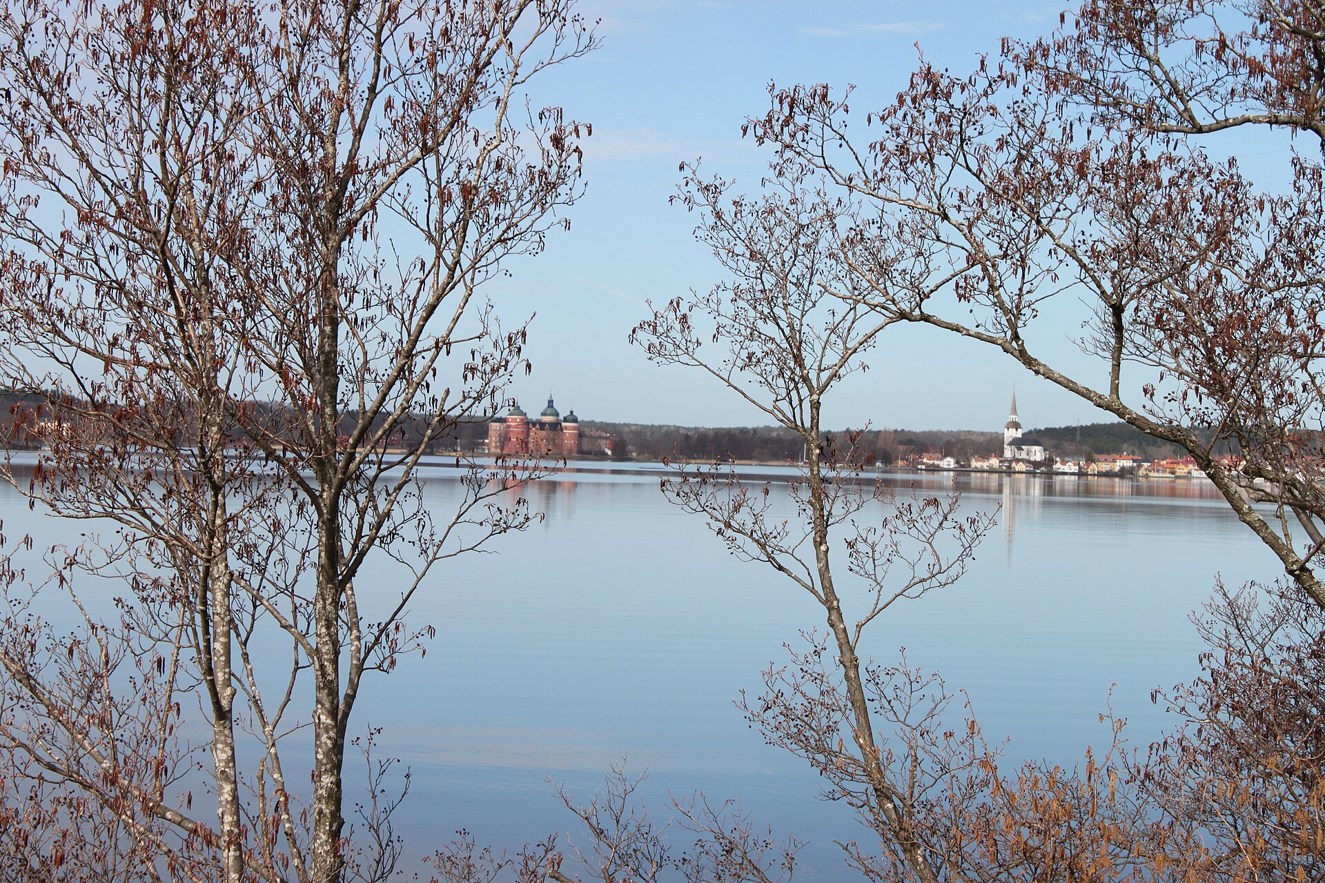 Gripsholm rises on an island in Lake Malaren, its round towers reflected in the calm water.
