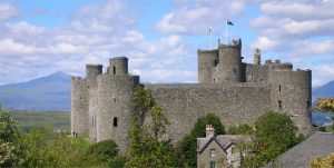 The castle set against the peaks of Snowdonia, with Snowdon itself rising beyond
