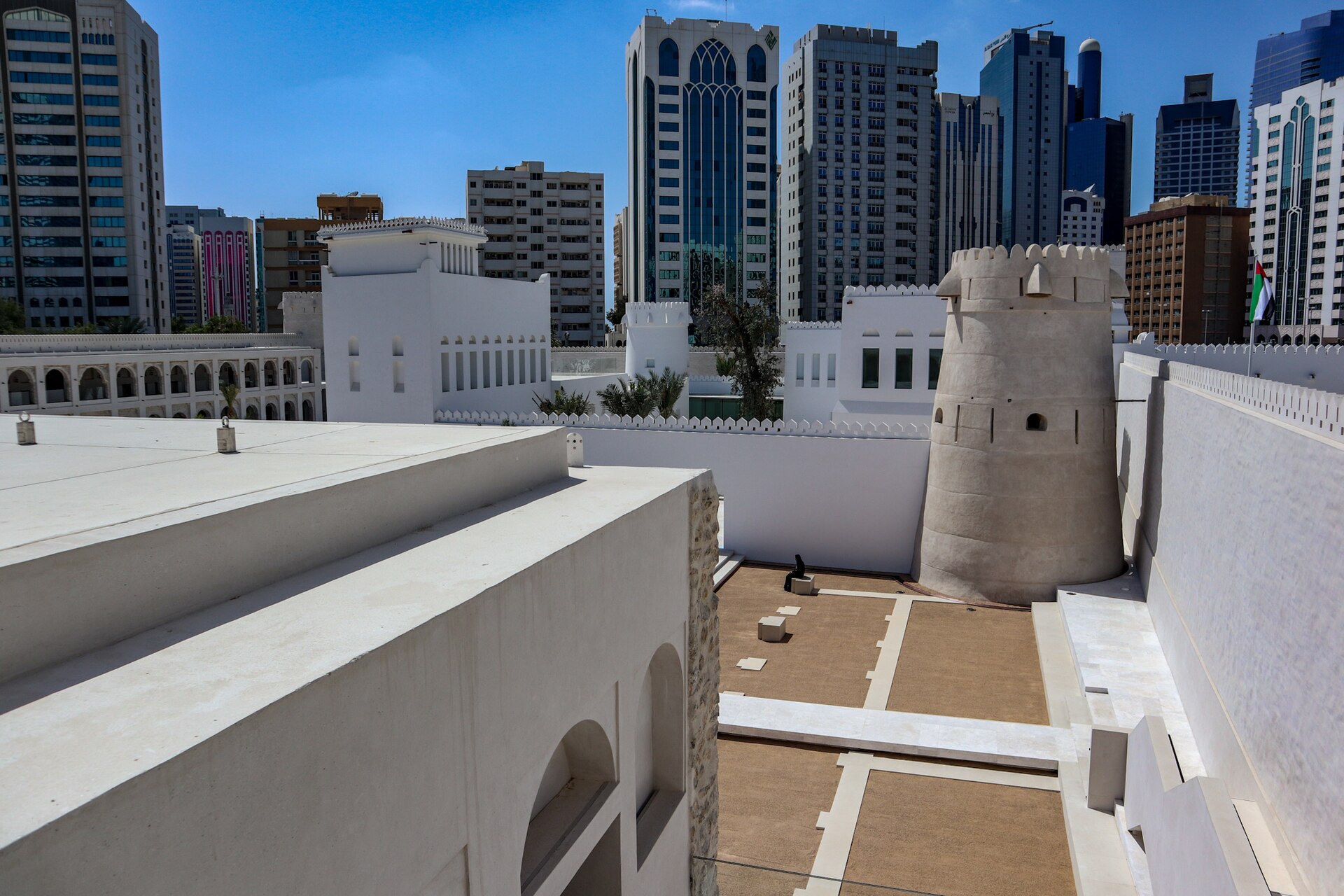 The old fort standing before the skyline of modern Abu Dhabi