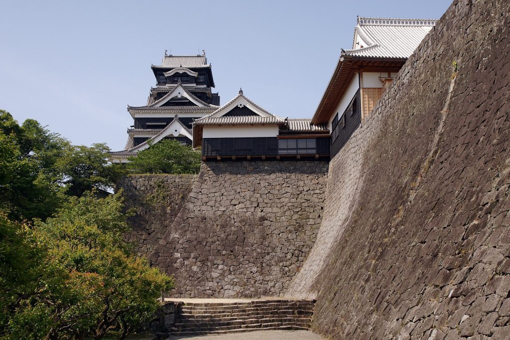 The imposing black keep of Kumamoto Castle rising above the city
