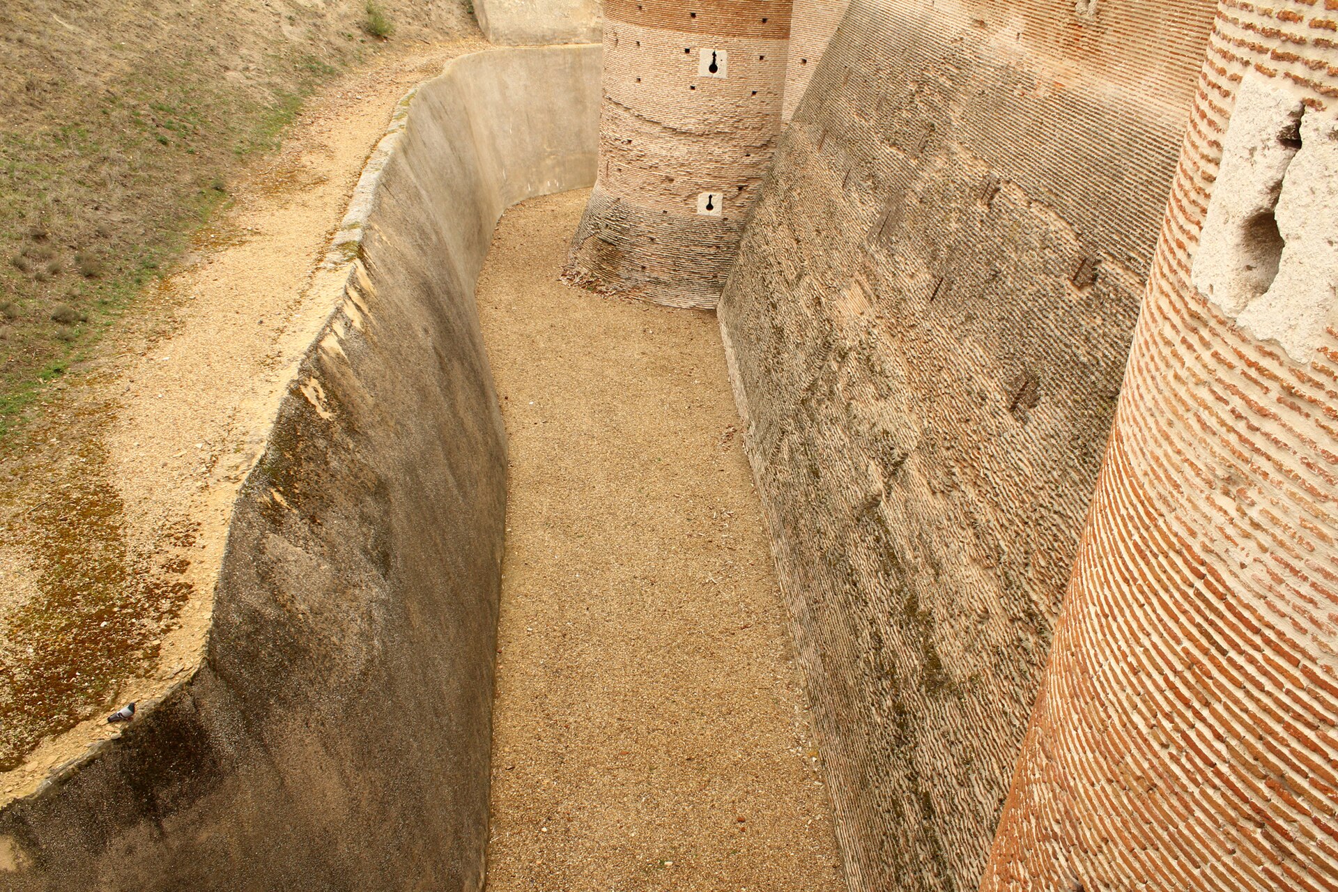 A massive square keep dominates the fortress and the plains around it.