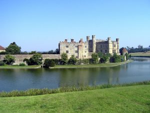The castle seems to float on the water, its walls mirrored in the surrounding moat