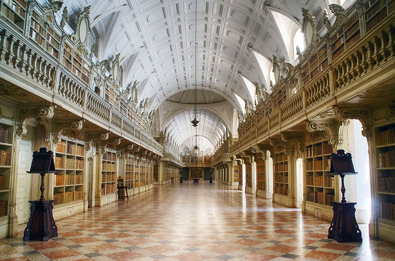 The Rococo library and its barrel-vaulted hall of books.