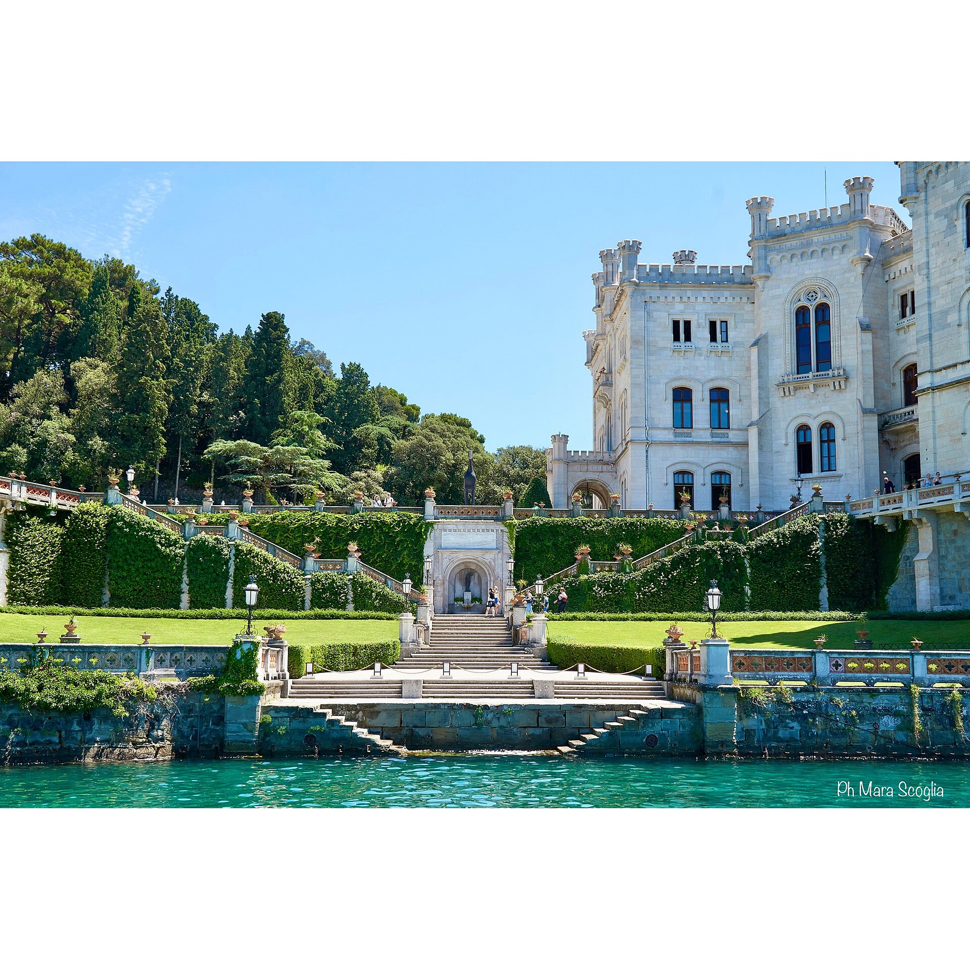 The gleaming white Castello di Miramare rising above the blue Adriatic