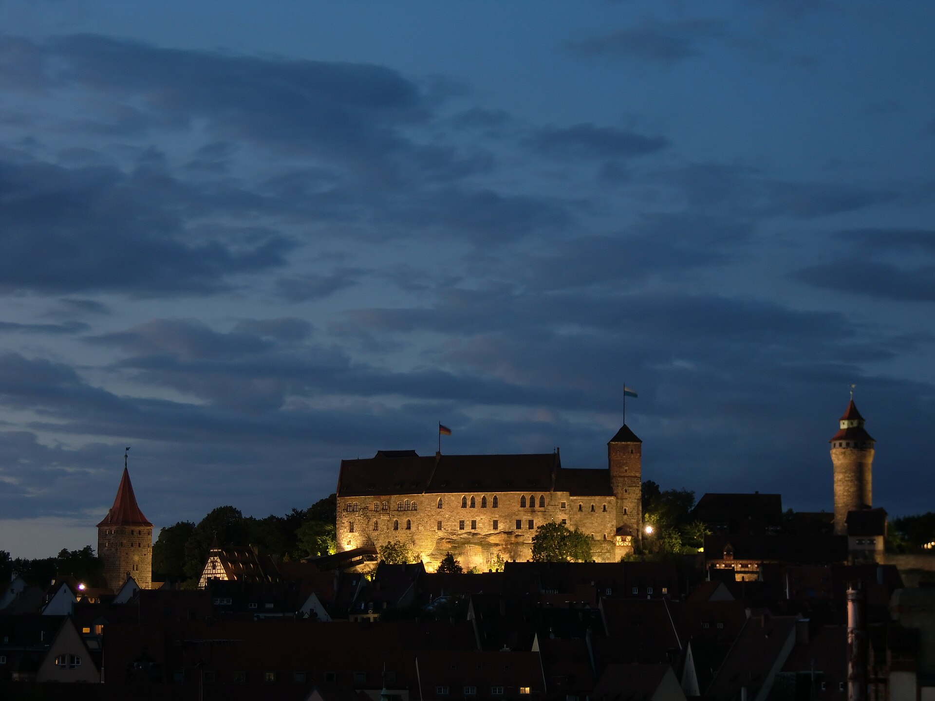 The floodlit castle, restored after the devastation of the twentieth century