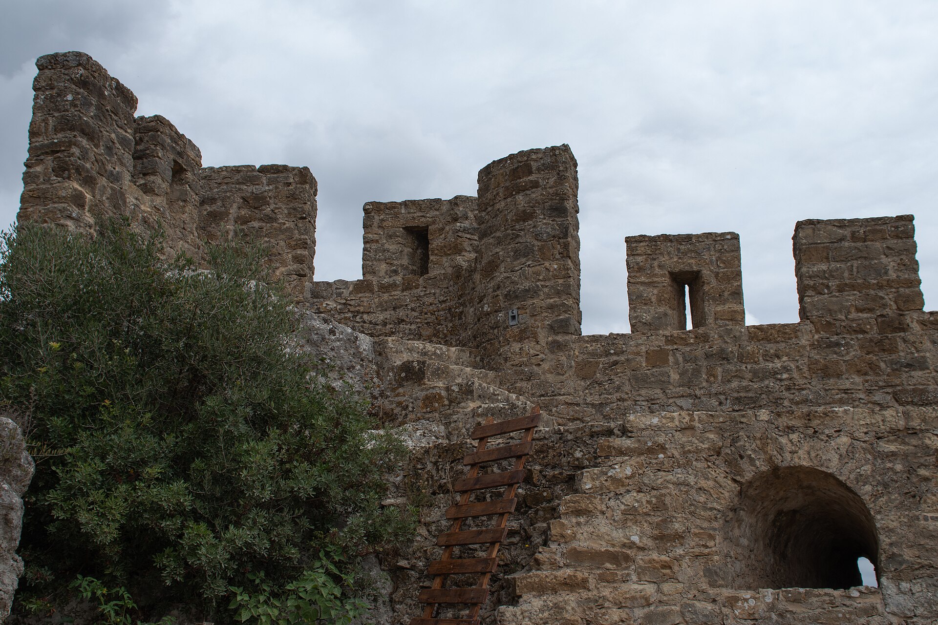 A complete circuit of battlemented walls encircles the whole town.